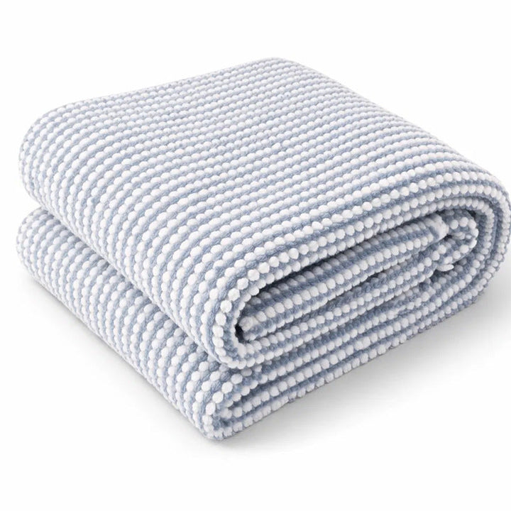 Strukturert vevd pledd i mykt design med elegant mønster. Ideelt som dekorativt teppe for stue, soverom og koselige hjem.