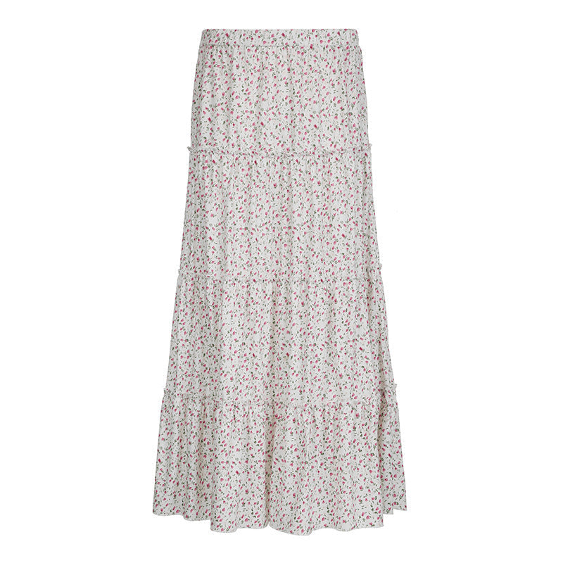 Langt, blomstret dame maxiskjørt med feminine volanger og elastisk midje. Ideelt for vår/sommer.