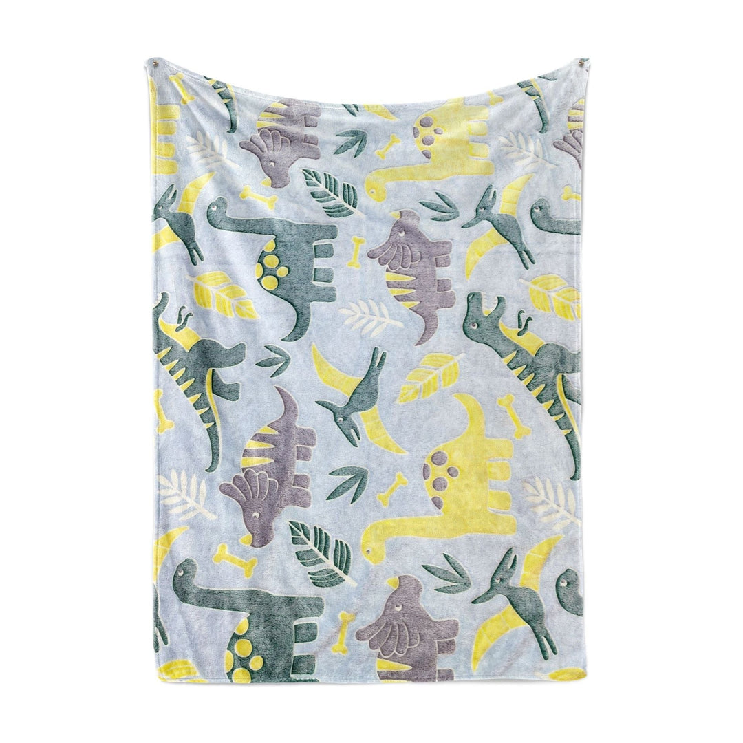 Barn koser seg under et stort, unisex dinosaur fleecepledd. Ideelt varmt teppe til filmkvelder.