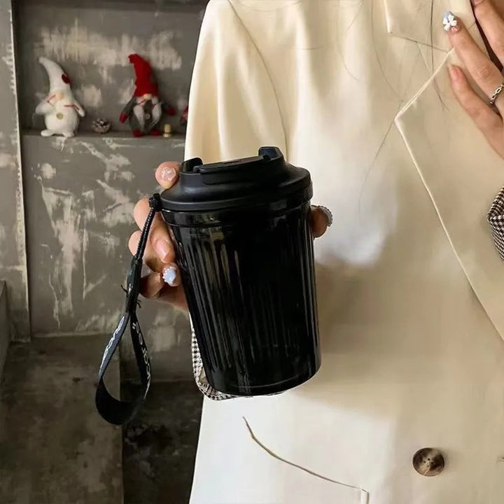 Elegant dame termoskopp med praktisk bærehåndtak for kaffe eller te på reisen. Sølesikker og lett å rengjøre.