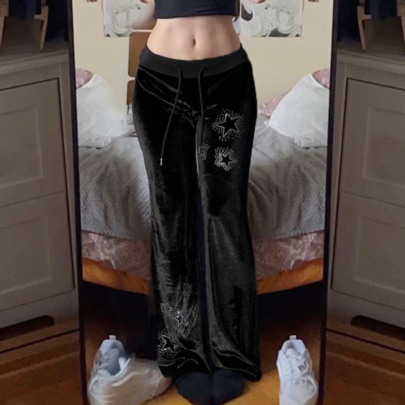 Moderne damebukser i flare-design med glitrende stjerner. Myke joggebukser for stil og komfort.
