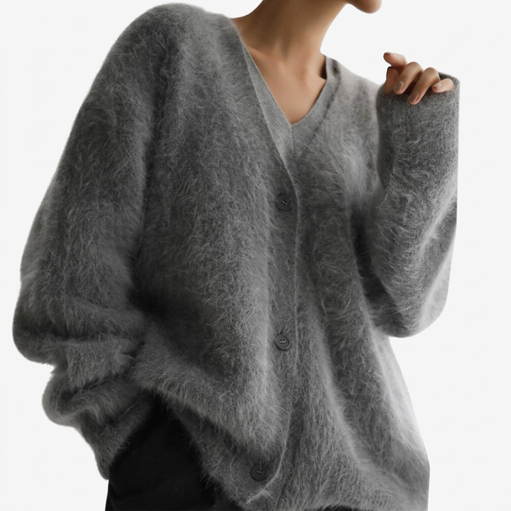 Elegante bakside av myk damecardigan med v-hals og knapper. Ensfarget design, komfortabelt koseplagg.