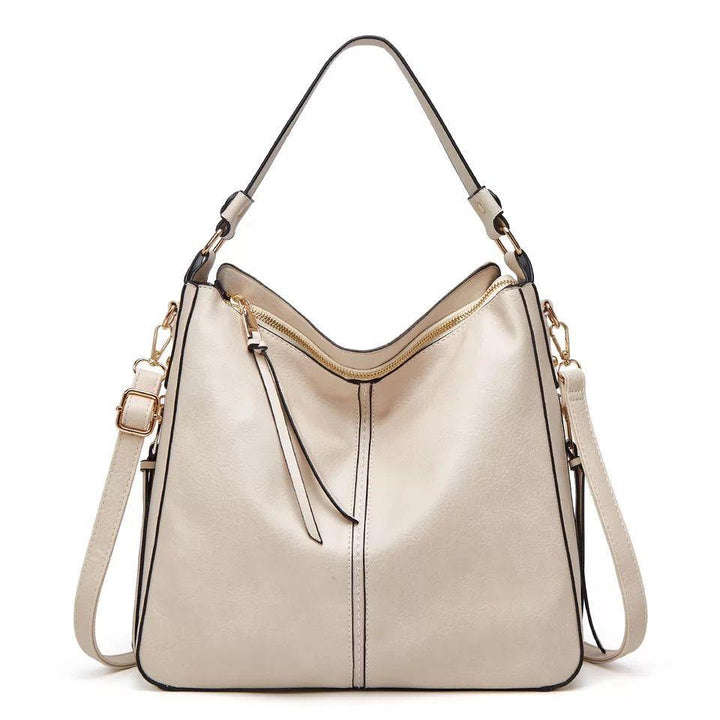 Stilfull skulderveske/crossbody i lær for kvinner, perfekt til hverdag og reise, organisert interiør.