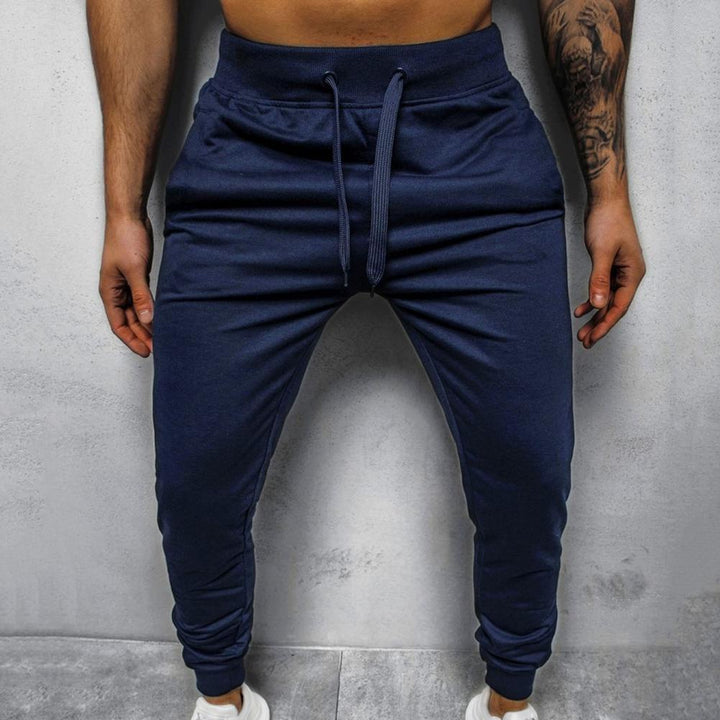 Herre treningsbukse slim fit med sidelinjer, gir bevegelsesfrihet og stil.