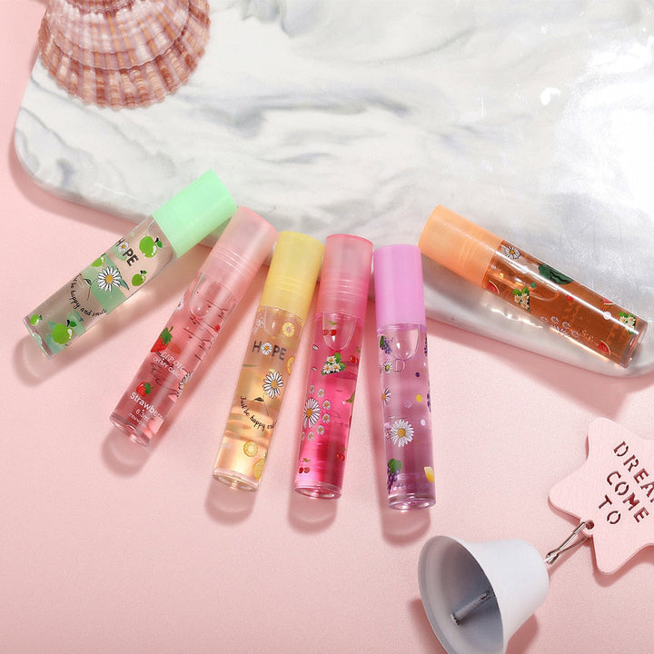 Skinnende fruktig lipgloss sett. 6 rulleball glosser som gir fuktighet og vann-glans til leppene.