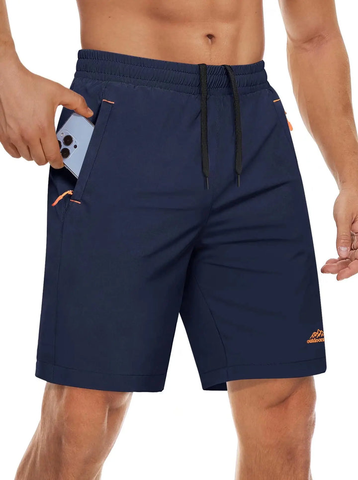 Svarte løpeshorts for herre, med reflekterende detaljer og glidelåslommer.
