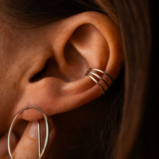 Elegant spiralformet øremansjett i glansfullt metall. Perfekt for en sofistikert stil.