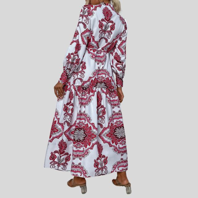 Elegant damekjole i maxilengde med fargerikt paisleymønster og lange ermer.