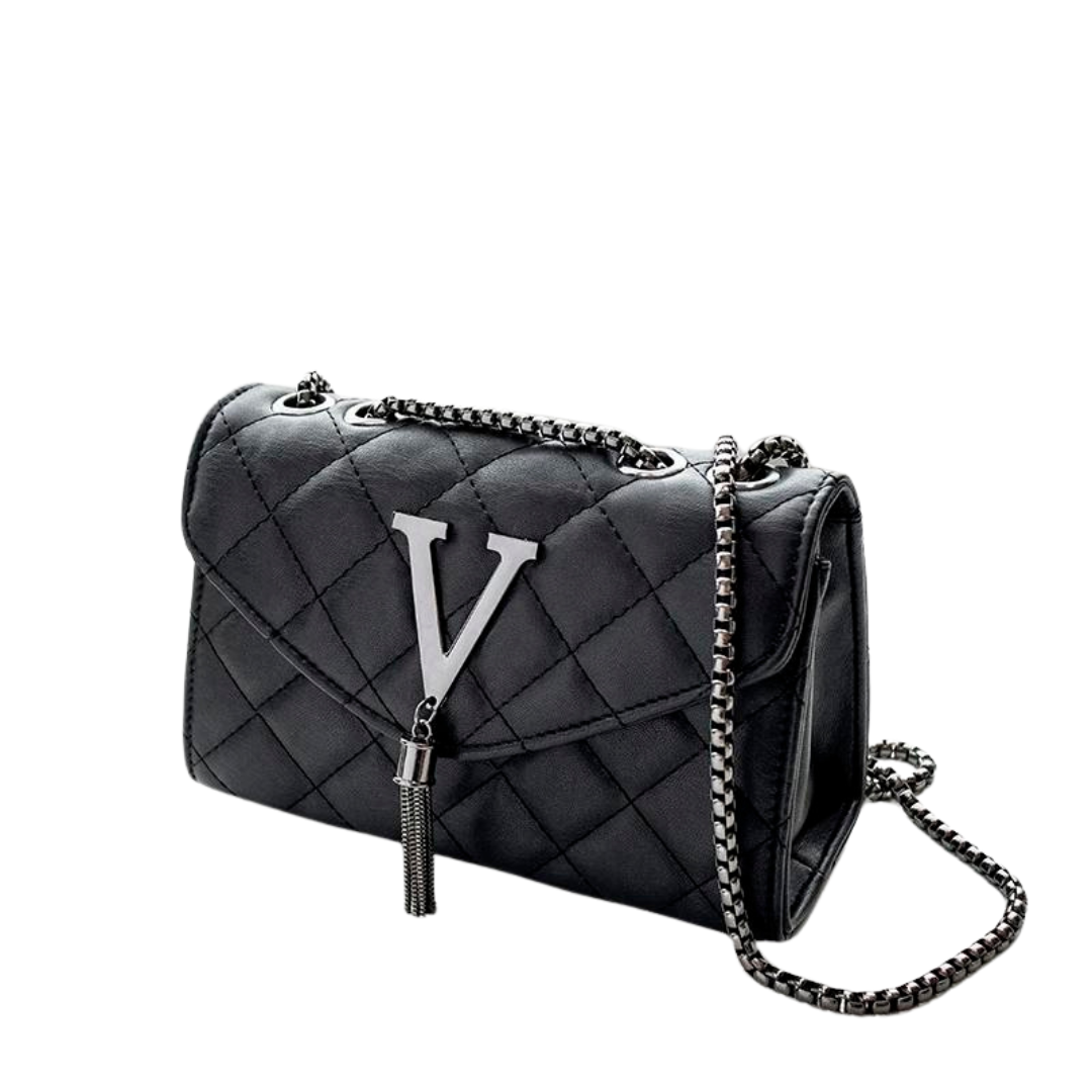 Elegant vattert crossbody veske for dame med dusker. Perfekt rutete skulderveske i svart eller hvit.