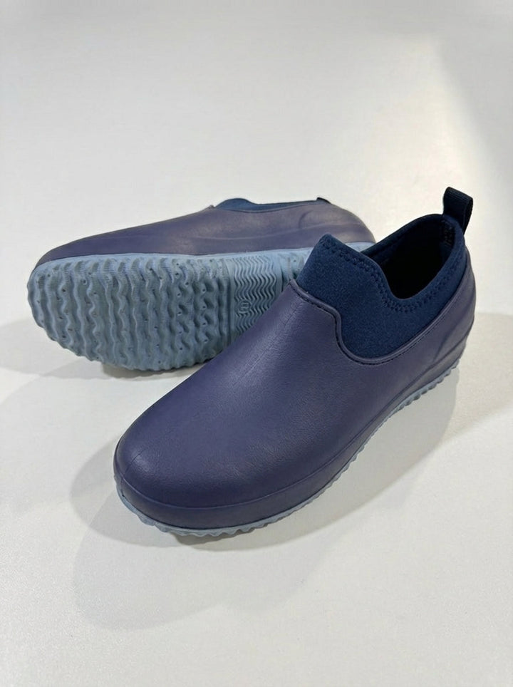 Menns slip-on arbeidssko i bruk, demonstrerer overlegen komfort og sikkerhet. Perfekt som praktiske, vanntette vernesko.