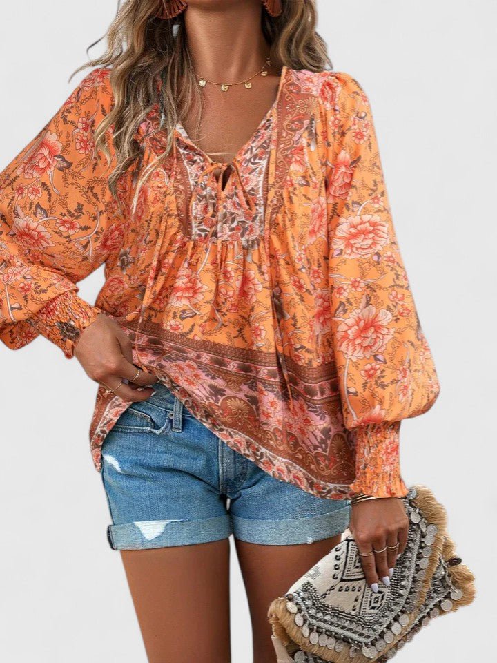 Avslappet og feminin boho bluse for kvinner med V-hals, puffermer og nydelig blomstertrykk.