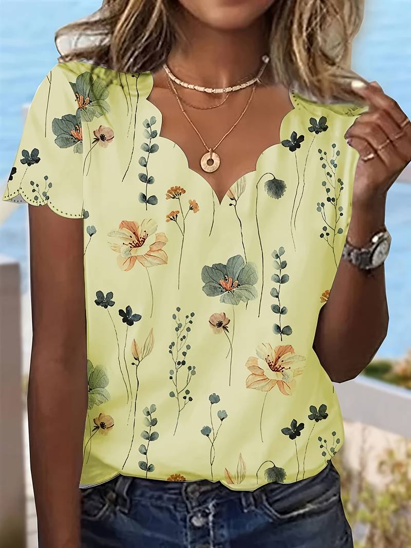 Vår- og sommerbluse med lekent blomstertrykk, perfekt for en casual look.