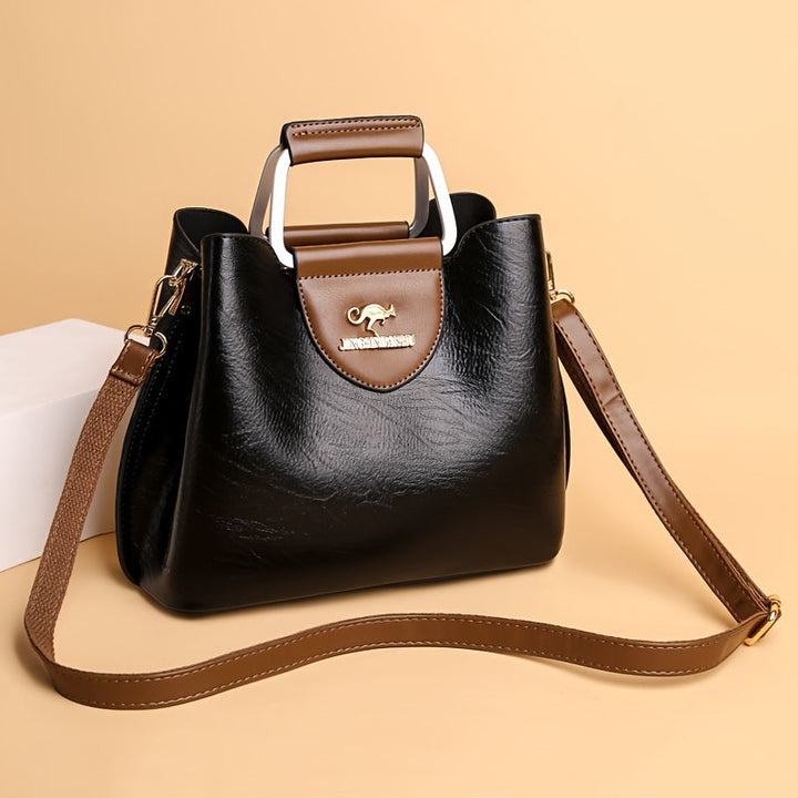 Elegant tofarget skinnveske for dame, med klassisk design og allsidig stil.