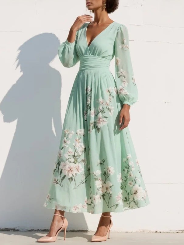 Klassisk elegant damekjole i midi-lengde med blomstertrykk, V-hals og ballongermer, ideell som bryllupsgjestkjole.