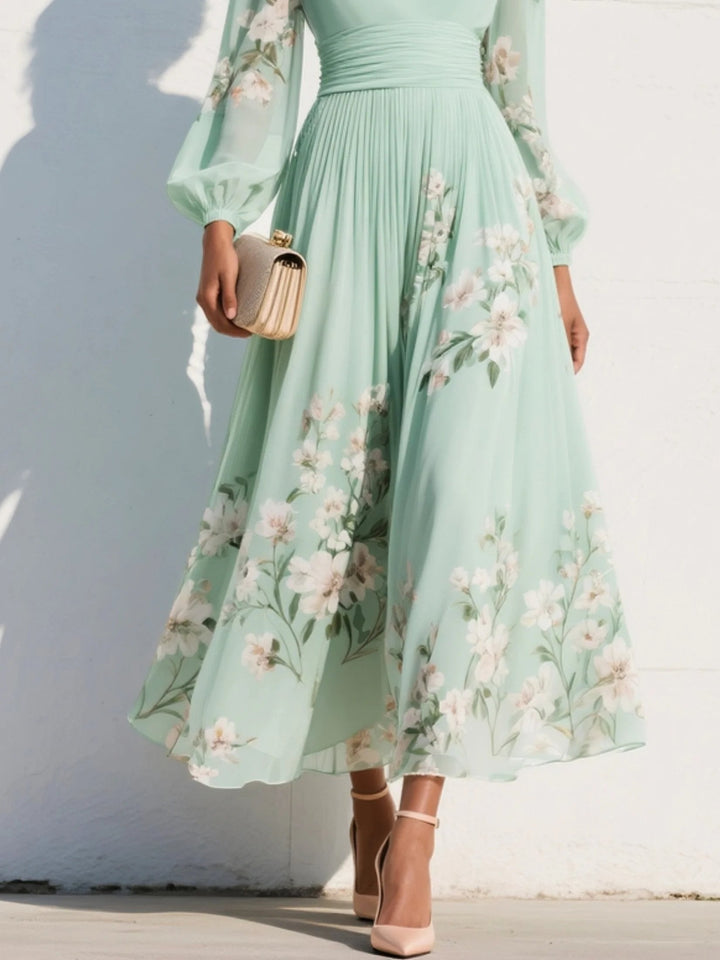 Kvinners blomstrete midi kjole med V-hals, voluminøse ballongermer og et elegant mønster. Perfekt som sommer- og festkjole.