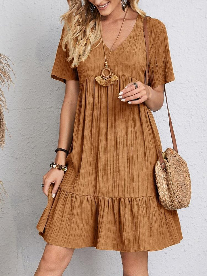 Elegant svart damekjole. V-hals babydollkjole med kortermer og volang, perfekt som sommerfestkjole.