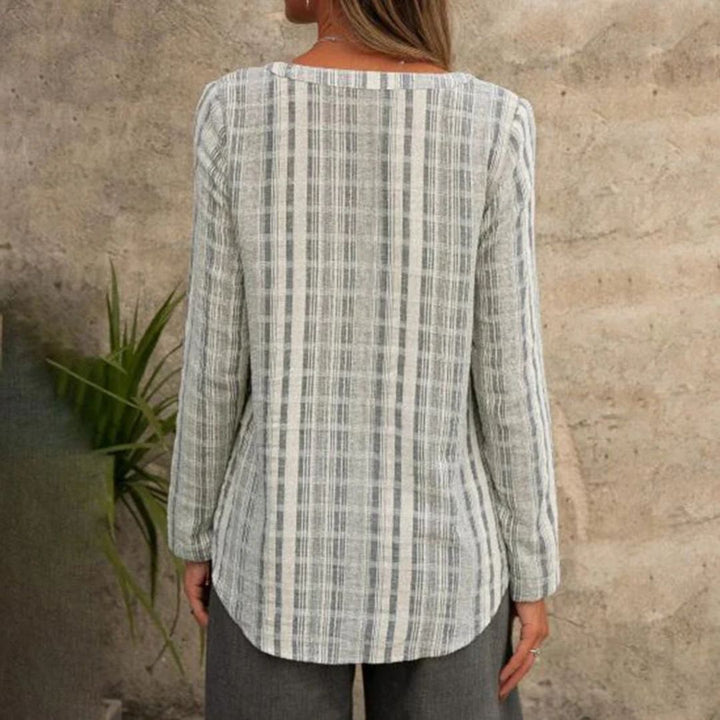 Stripete langermet damebluse med flatterende V-hals, perfekt for en moderne og komfortabel fritidslook.