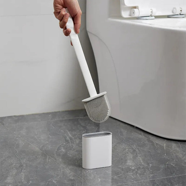Innovativ toalettbørste med fleksibelt silikonhode og veggfeste for grundig og enkel husvask.