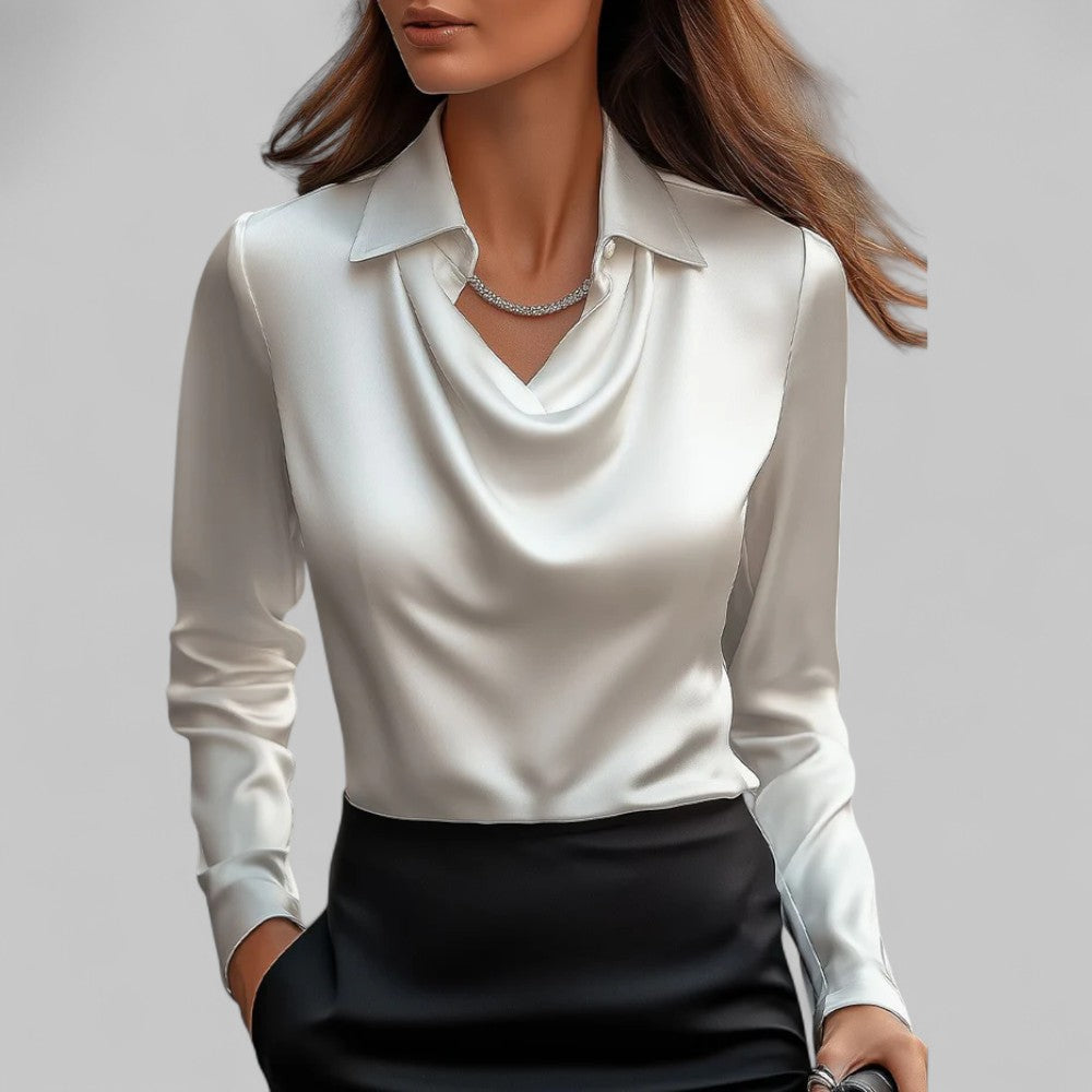 Damebluse med tidløs stil. Myk bluse med lange ermer og elegant vannfallutringning.