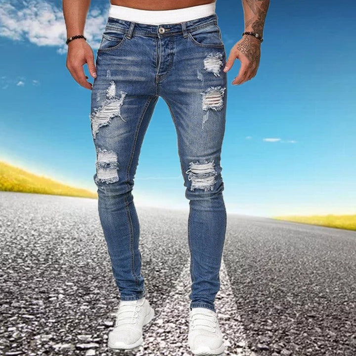Unike herrejeans: Slim-fit denim med tydelige rifter og slitt effekt for en urban stil.