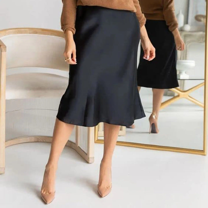Dame skjørt, A-linjeformet og knelangt. Høy midje gir et elegant og tidløst preg til enhver garderobe.
