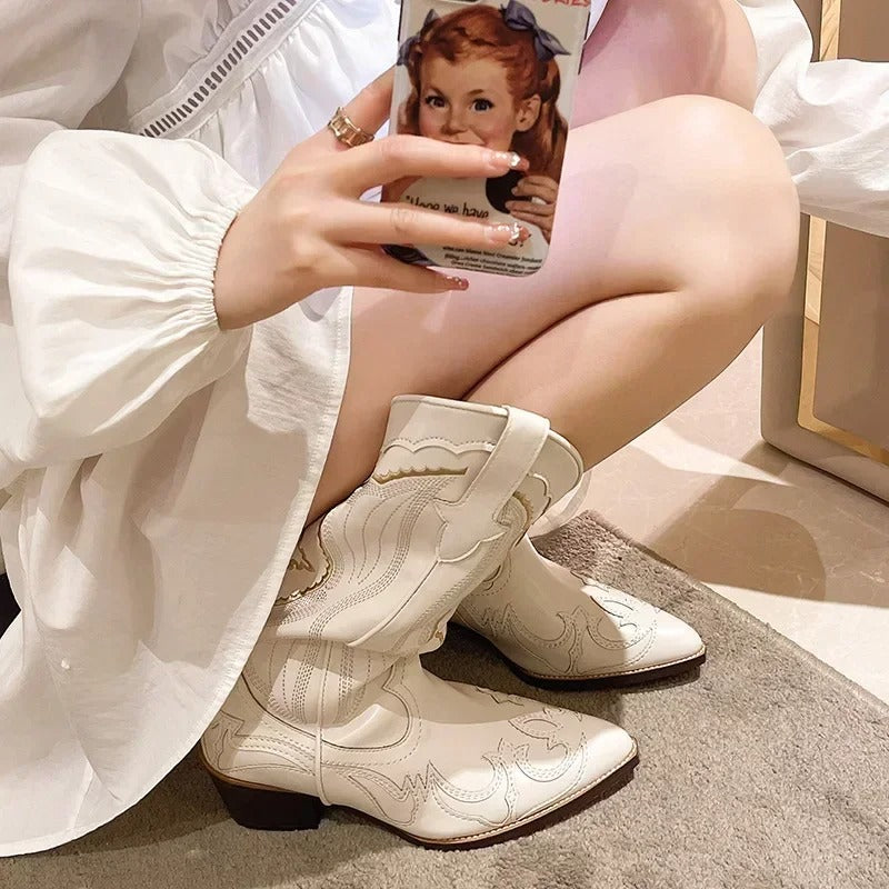 Tekstur og broderidetaljer på elegante midcalf-støvler, et must for den stilbevisste kvinnen.