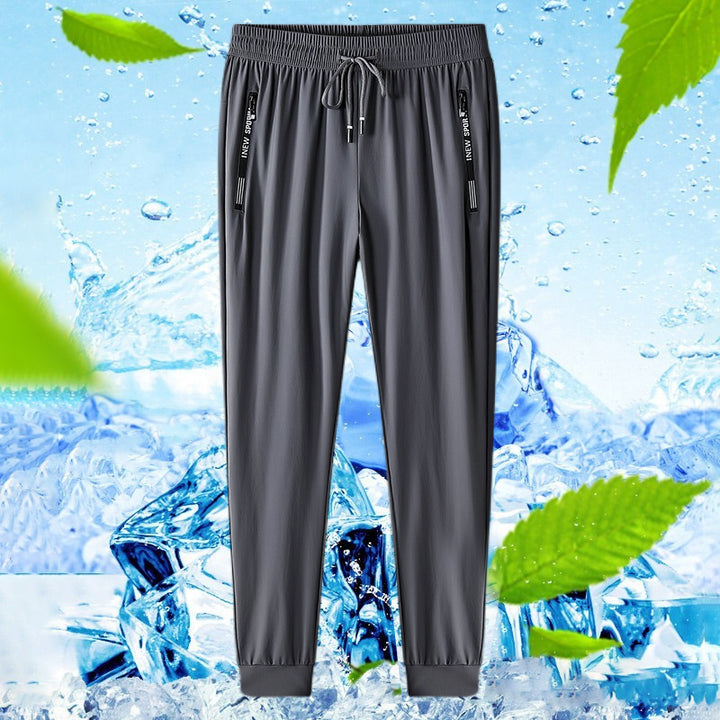 Unisex sportsbukser i svart nylon, med hurtigtørkende stretch for trening og aktiv bruk.