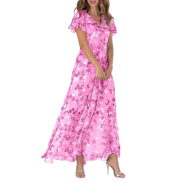Vakker dame blomsterkjole med fargerikt mønster og sommerfuglsleeves. En luftig lang kjole.