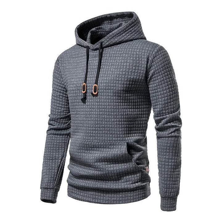 Stilig lappeteppe hettegenser for menn. Myk og behagelig pullover med hette og snøringsdetaljer.