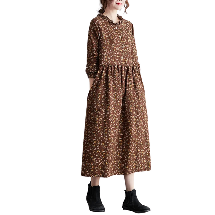 Blomstret vintage damekjole med volanger og lange ermer. Komfortabel og løs passform til hverdag.