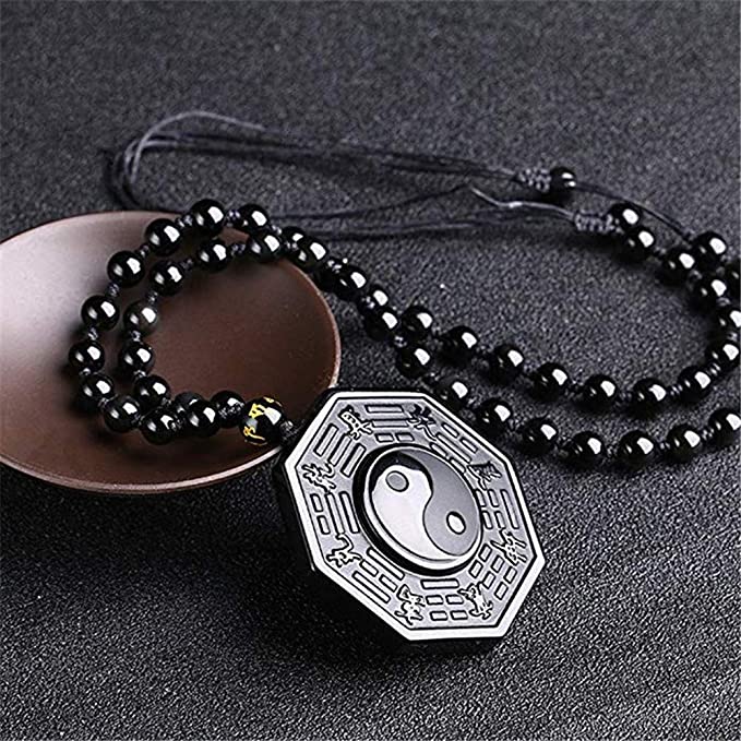 Smykke med autentisk obsidian yin yang. Fremmer indre ro, energi og åndelig balanse.